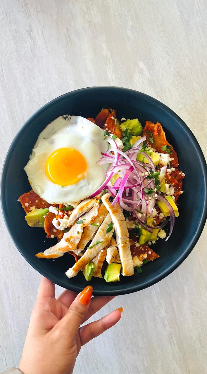 Chilaquiles Rojos with chipotle and guajillo at BOTICA BISTRO Playa del Carmen